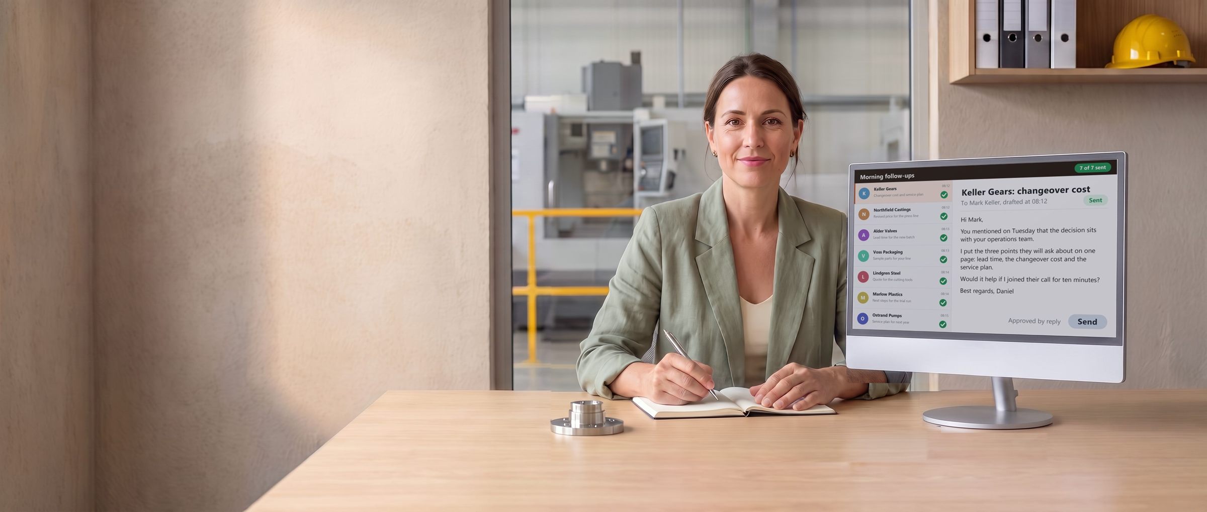 A sales rep at her desk in a manufacturer's sales office, next to a monitor that lists every stalled deal with a green tick.